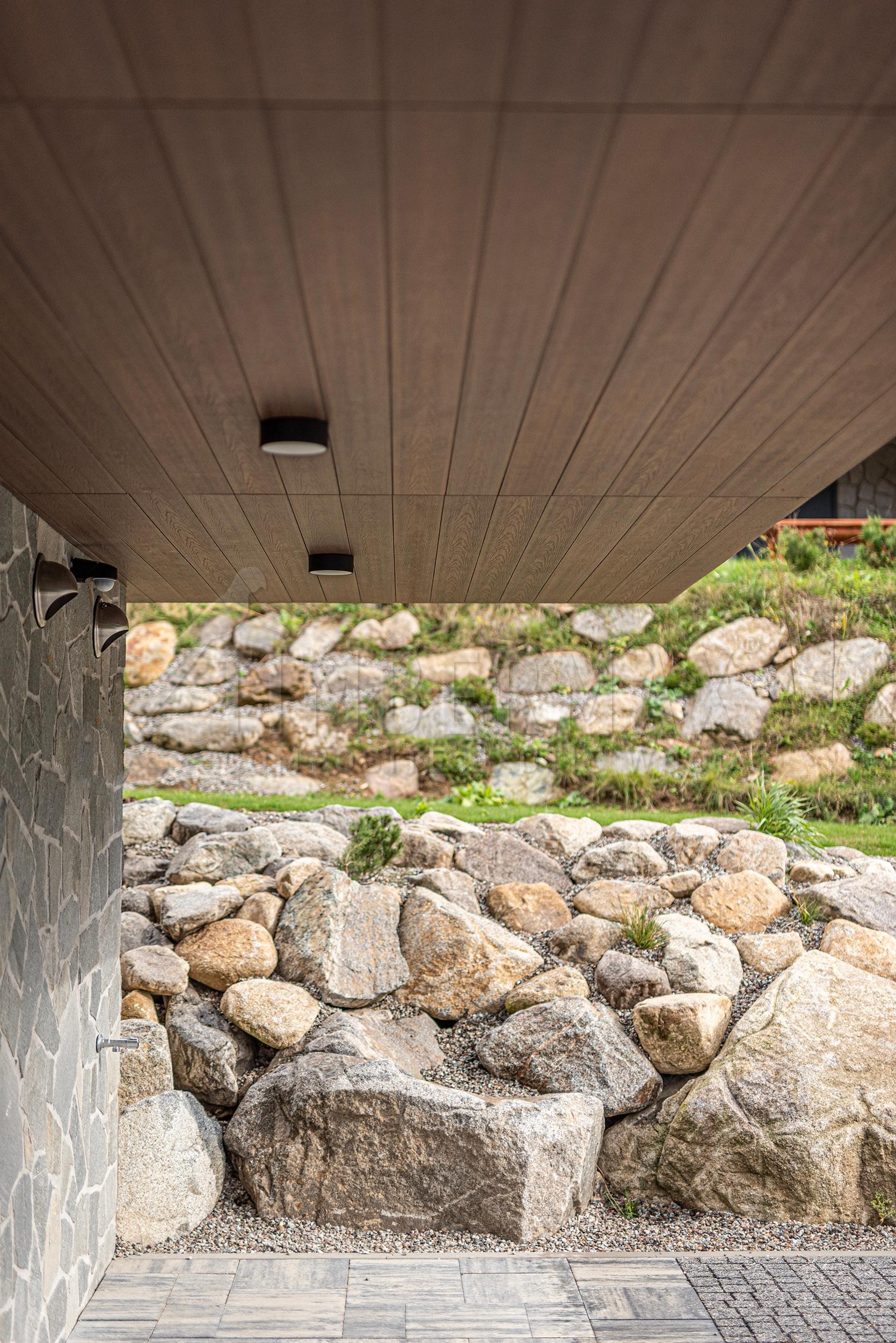 architektonický detail podhledu a fasády s kompozitním obkladem imitace dřeva